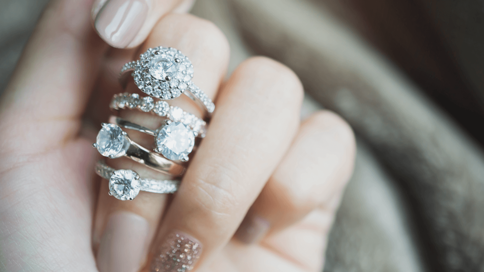 Close up of elegant diamond engagement rings on woman's finger