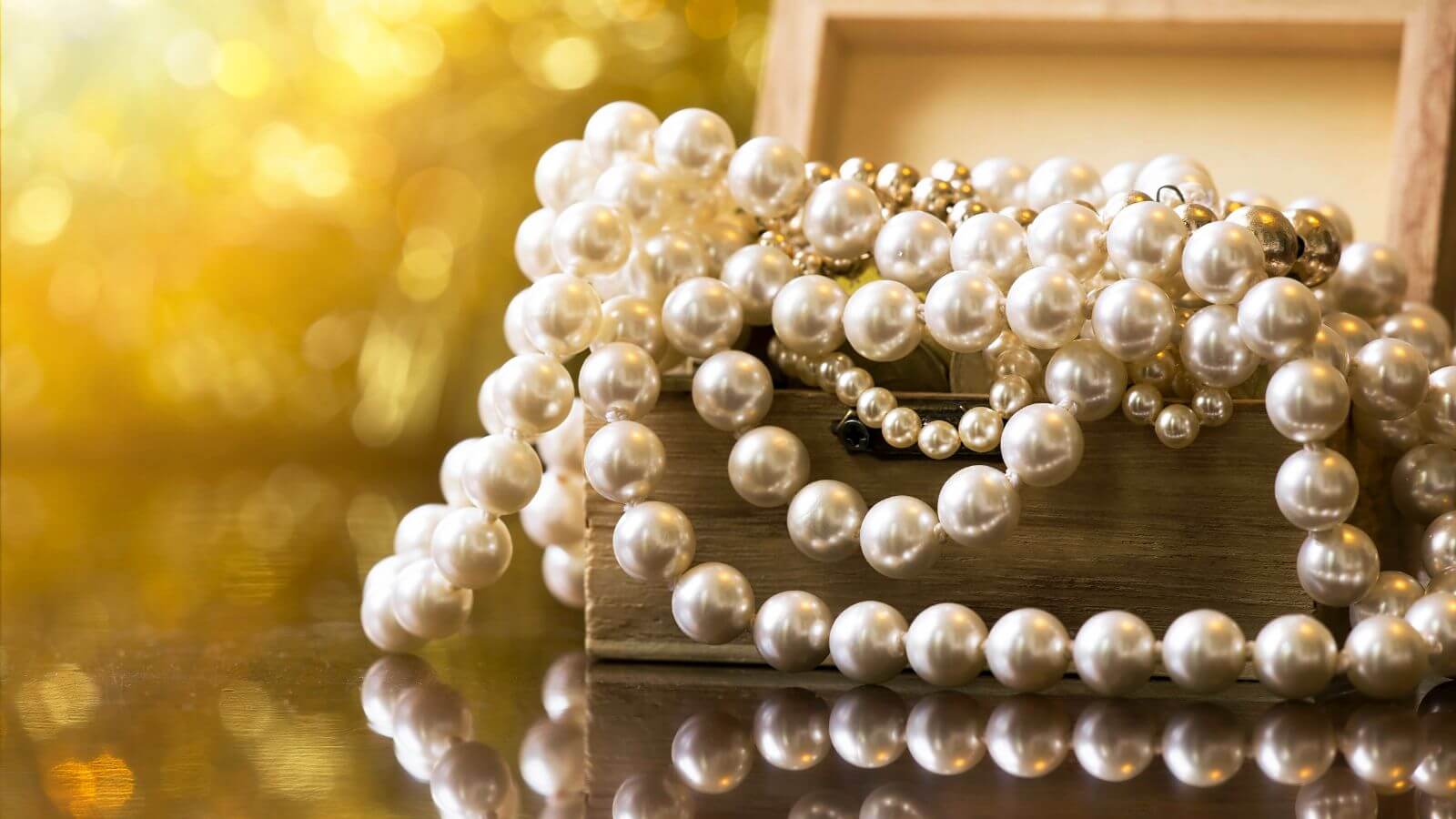 pile of pearls in a wooden box