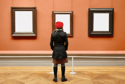 woman looking at frames in art museum